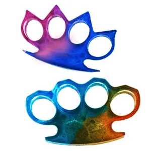 Macro view of colorful resin brass knuckle accessories featuring a glitter gradient finish