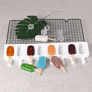 Macro view of white 8-cavity silicone ice pop mold with colorful DIY popsicles