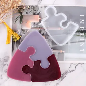 Macro view of a creative puzzle-shaped silicone mold and finished DIY resin coasters.