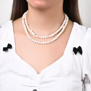 Gros plan d'un collier de perles d'eau douce baroques à deux rangs sur le cou d'un mannequin