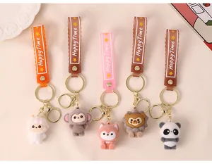 Close-up view of five cute flocked animal keychains featuring panda, lion, and fox designs