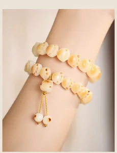 Detail of toasted cat paw beads on natural white jade bodhi root bracelet for women