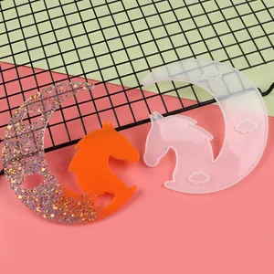 Detailed macro view showing a translucent moon horse silicone mold and its orange glitter resin cast.