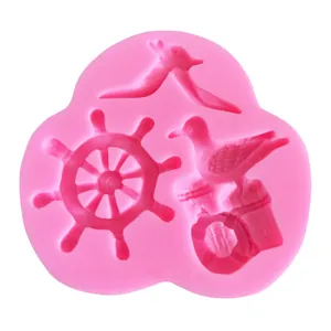 Detailed view of a nautical themed pink silicone mold featuring a seagull and ship wheel