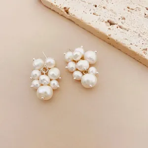 Detail showing the elegant cluster texture of freshwater pearl grape earrings on warm background