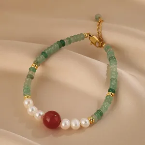 Detail of aventurine beaded bracelet with freshwater pearls and red agate