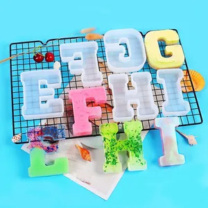 Detail view of large letter silicone molds with colorful finished resin alphabet pieces