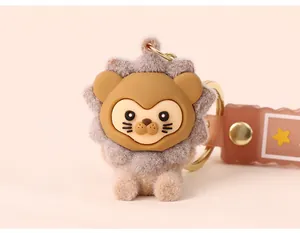 Close-up of cute flocked lion doll keychain with soft rubber face and golden ring
