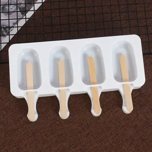 White 4-cavity silicone popsicle mold with wooden sticks on a textured brown background