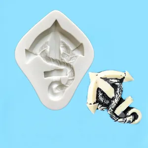 Macro detailed view of a pirate ship anchor silicone mold with a finished fondant product example