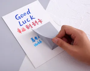 Detailed view of peeling a silver DIY scratch-off sticker from a handwritten card