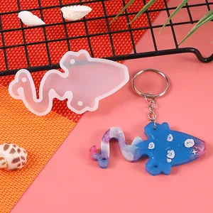 Detailed macro view of silicone resin mold alongside a finished blue galaxy keychain