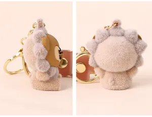 Detailed macro view of the soft flocked texture and golden clasp on the lion doll keychain