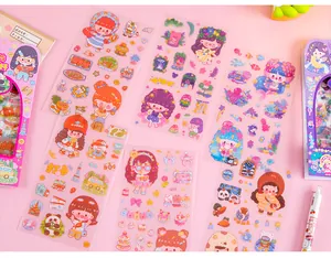 Detail shot of four cute cartoon sticker sheets for DIY journals and planning