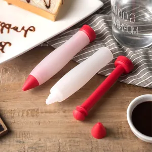 Silicone chocolate piping pen set for cake decorating and DIY baking on wooden table