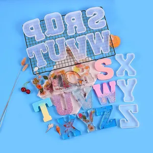 Detailed view of DIY resin alphabet molds and various decorated finished letters