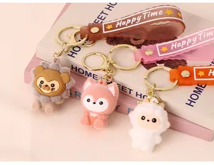 Close-up view of three cute flocked animal keychains with Happy Time wrist straps