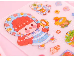 Close-up detail of cute cartoon character stickers with glitter finish for DIY journaling