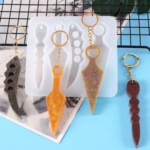 Detail of silicone mold and resin keychains in kunai and dagger shapes