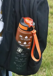 Orange 1000ML gradient water bottle with time markers in a black backpack pocket