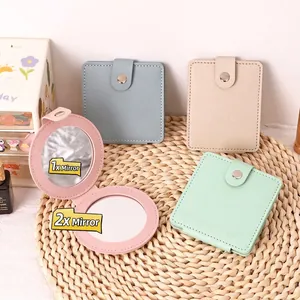 Portable folding PU leather makeup mirror with 1x and 2x magnification for travel.