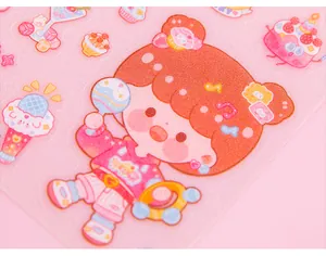 Close-up of cute cartoon girl stickers with glitter texture for DIY handbook decoration.