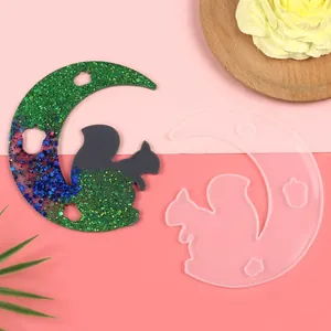 Detail of crescent moon and squirrel silicone resin mold with finished glitter piece