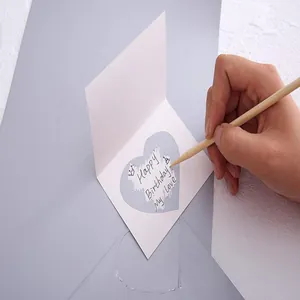 Close-up of heart-shaped DIY scratch-off sticker revealing a secret birthday message