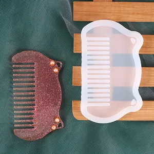 Detailed close-up of a DIY resin comb mold with a pink glitter finished product