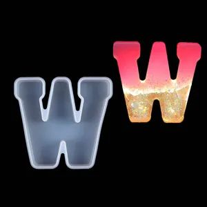 Detailed view of Letter W silicone mold and finished glitter resin piece