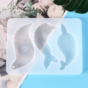 Translucent silicone mold featuring three distinct dolphin and whale shapes for resin DIY
