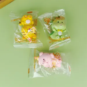 Detailed view of three resin cartoon animal figurines in individual plastic packaging.