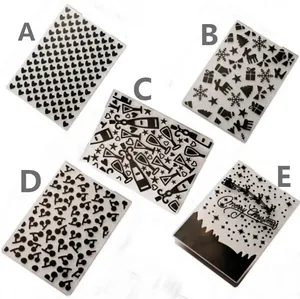 Macro view of five DIY plastic embossing folders with various festive patterns.