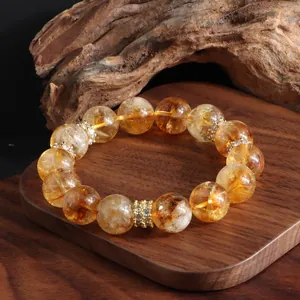 Natural citrine bead bracelet with sparkling crystal spacers shown on wooden base