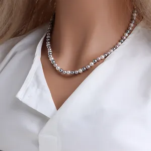 Gros plan d'un collier de perles de nacre vintage multicolores sur un mannequin