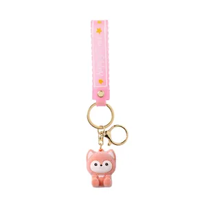 Cute flocked peach fox keychain featuring a pink silicone strap for backpack decoration