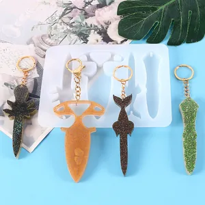 Detailed view of DIY resin keychains with glitter finish and matching white silicone mold
