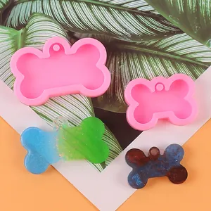 Detail of bone-shaped silicone molds and glitter resin craft tags