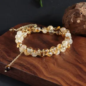 Detailed view of natural yellow citrine and tiger's eye double-strand crystal bracelet