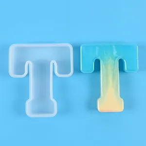 Detail view of the letter T silicone mold shown with a finished blue gradient resin piece