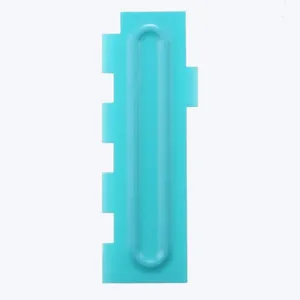 Detailed close-up view of a turquoise plastic cake scraper comb tool for DIY baking decor
