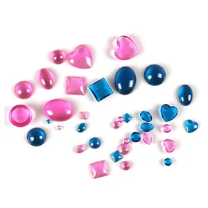 Detailed view of colorful translucent resin heart and oval charms for DIY jewelry