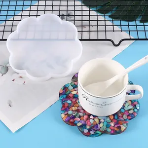 Detail view of flower-shaped silicone coaster mold and colorful pebble resin finished product