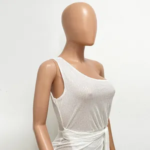 Detail view of white one-shoulder sequin dress with pleated waist and sash belt.