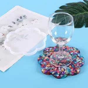 Detailed view of flower-shaped silicone mold with a finished colorful resin coaster