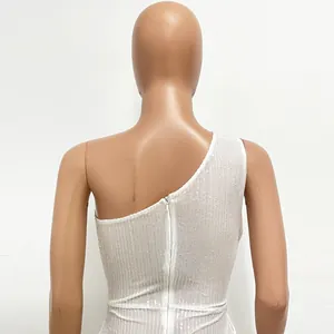 Detailed back view of a white sequined one-shoulder dress showing invisible zipper closure