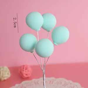 Detailed view of the 2.5cm mint green clay balloon cake topper on silver wire