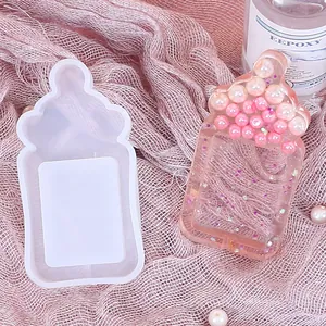 Detailed macro view of baby bottle shaped silicone mold for DIY crystal epoxy resin crafts.