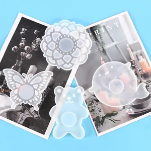 Detailed view of translucent silicone coaster molds in butterfly and animal shapes