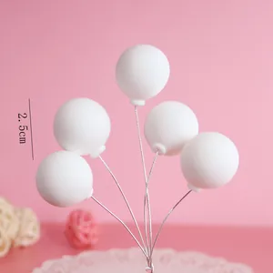 Close-up of white soft clay balloon cake toppers with 2.5cm diameter on wire